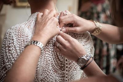 Bride getting ready, pearl-embroidered wedding dress