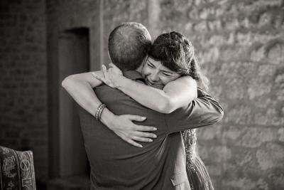 Emotional embrace between guests, black and white wedding photography