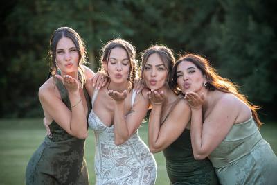 Bridesmaids blowing kisses in the golden evening light