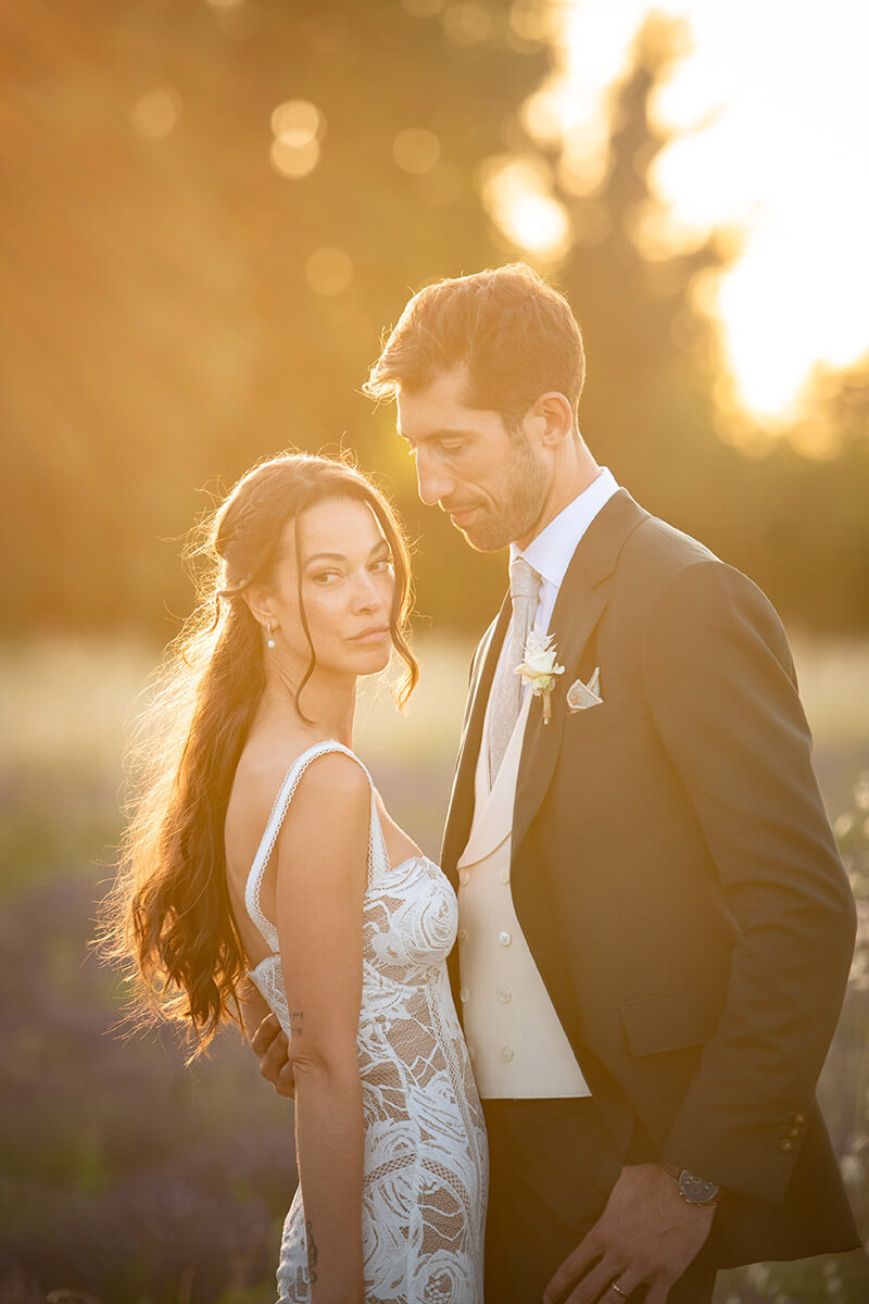 Bride and groom backlit by the setting sun, Provence wedding